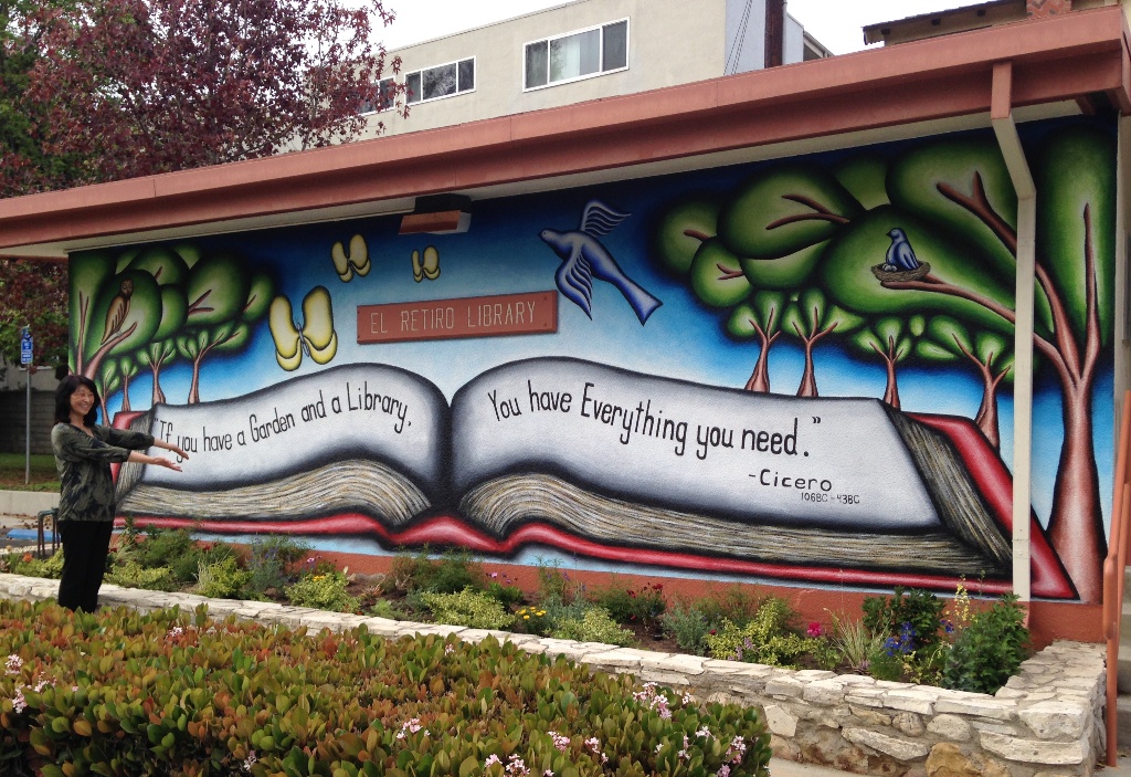 Supervising Librarian Kay Ujimori shows off the new wall mural and gardens at El Retiro