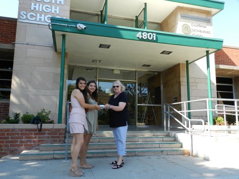 2016 Scholarship winners Regina Mettey and Annaliese Segoviano receiving last year's scholarship awards